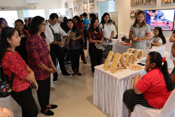 Prima explains her businesses and products to the guests.
